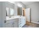 Bright bathroom with double sinks, ample counter space, shaker style cabinets, and decorative mirrors at 658 Bennett Mountain Trce, Chapel Hill, NC 27516