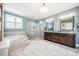 Bathroom featuring marble tiled floors, a soaking tub with steps, and glass shower at 658 Bennett Mountain Trce, Chapel Hill, NC 27516