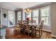 Bright dining room with a wooden table, seating for eight, and large windows showcasing the lush outdoors at 658 Bennett Mountain Trce, Chapel Hill, NC 27516