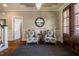 Well-appointed foyer with a chandelier, two armchairs, decorative mirror, and hardwood floors at 658 Bennett Mountain Trce, Chapel Hill, NC 27516