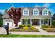 Charming home featuring an attached garage, manicured landscaping, dormer windows, and a welcoming front porch at 658 Bennett Mountain Trce, Chapel Hill, NC 27516