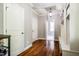 Well-lit hallway with hardwood floors, white trim, and convenient built-in storage with a bench at 658 Bennett Mountain Trce, Chapel Hill, NC 27516