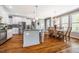 Open concept kitchen with a gray island, stainless steel appliances and natural light at 658 Bennett Mountain Trce, Chapel Hill, NC 27516
