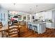 Open-concept kitchen with stainless steel appliances, granite countertops, and island seating in a bright, modern home at 658 Bennett Mountain Trce, Chapel Hill, NC 27516