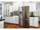 Modern kitchen with stainless steel refrigerator, microwave, and ample counter space at 658 Bennett Mountain Trce, Chapel Hill, NC 27516