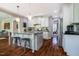 Bright kitchen featuring a kitchen island with pendant lights, stainless steel appliances, and hardwood floors at 658 Bennett Mountain Trce, Chapel Hill, NC 27516