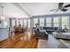 Open concept living and dining area with a large sectional and bright, natural light at 658 Bennett Mountain Trce, Chapel Hill, NC 27516