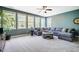 Spacious living room with large windows, plush gray sectional, and neutral carpet at 658 Bennett Mountain Trce, Chapel Hill, NC 27516
