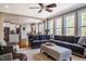 Bright living room with hardwood floors, large windows, a corner fireplace, and comfortable seating at 658 Bennett Mountain Trce, Chapel Hill, NC 27516
