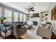 Cozy living room with fireplace, built-in shelving, large windows, comfortable seating and hardwood floors at 658 Bennett Mountain Trce, Chapel Hill, NC 27516