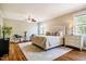Bright main bedroom with hardwood floors, ceiling fan, natural light, and sitting area at 658 Bennett Mountain Trce, Chapel Hill, NC 27516
