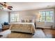 This main bedroom offers two bedside tables, ceiling fan, and a plush rug at 658 Bennett Mountain Trce, Chapel Hill, NC 27516