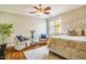 This main bedroom offers hardwood floors, sitting area, and a ceiling fan at 658 Bennett Mountain Trce, Chapel Hill, NC 27516