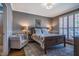 Inviting main bedroom with a large bed, stylish decor, and ample natural light from shuttered windows at 658 Bennett Mountain Trce, Chapel Hill, NC 27516