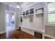 Mudroom with built-in storage, wooden floors, and convenient access to laundry room at 658 Bennett Mountain Trce, Chapel Hill, NC 27516