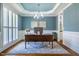 Charming home office with natural light, plantation shutters, and a modern chandelier at 658 Bennett Mountain Trce, Chapel Hill, NC 27516