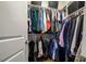 Organized walk-in closet with double hanging rods, wooden floor, overhead shelving, and ample storage space at 658 Bennett Mountain Trce, Chapel Hill, NC 27516