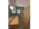 Bathroom with dual sinks, a vanity mirror, wallpaper, and access to the shower/tub at 683 Osgood Rd, Sanford, NC 27330