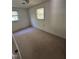 Bedroom with two windows providing natural light and neutral colored carpet at 683 Osgood Rd, Sanford, NC 27330