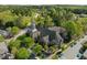 Aerial view of church surrounded by trees and street front parking at 703 Copperline Dr # 301, Chapel Hill, NC 27516