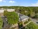Aerial view of a two-story brick building with street front parking and mature landscaping at 703 Copperline Dr # 301, Chapel Hill, NC 27516