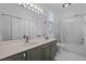 Bathroom with bright vanity, large mirror, tub, and shower at 703 Copperline Dr # 301, Chapel Hill, NC 27516