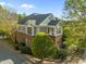 Exterior elevation of a two-story brick building with green siding and mature landscaping at 703 Copperline Dr # 301, Chapel Hill, NC 27516