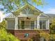 Charming exterior view of a two-story home, featuring a covered porch with brick and siding accents at 703 Copperline Dr # 301, Chapel Hill, NC 27516