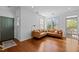 Inviting living room with a leather sectional sofa, wood floors and natural light streaming through the window at 703 Copperline Dr # 301, Chapel Hill, NC 27516