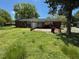Backyard with lawn and a view of the back of a single Gathering home at 706 Orchard Dr, Graham, NC 27253