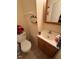 Small bathroom featuring a sink, vanity, and mirror with a toilet at 706 Orchard Dr, Graham, NC 27253