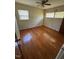 Bright bedroom with hardwood floors, two windows, and ceiling fan at 706 Orchard Dr, Graham, NC 27253