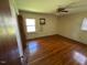 Spacious bedroom with hardwood floors and lots of natural light with a ceiling fan at 706 Orchard Dr, Graham, NC 27253
