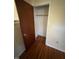 Empty walk-in closet with shelving and a wooden floor at 706 Orchard Dr, Graham, NC 27253