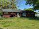 Well-maintained brick home with a lush front yard and mature landscaping at 706 Orchard Dr, Graham, NC 27253