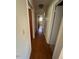 Hallway featuring hardwood floors and neutral walls leading to various rooms at 706 Orchard Dr, Graham, NC 27253