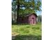 A red wooden shed with rustic charm, perfect for extra storage at 706 Orchard Dr, Graham, NC 27253