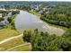 Aerial view of the community lake bordered by lush trees and homes at 707 Southshore Pkwy, Durham, NC 27703