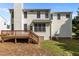 Exterior view of a home featuring a wooden deck and a spacious backyard with trees at 707 Southshore Pkwy, Durham, NC 27703