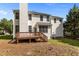 Exterior view of a home featuring a wooden deck and a spacious backyard with trees at 707 Southshore Pkwy, Durham, NC 27703