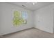 Bright bedroom featuring a ceiling fan and large window with verdant outdoor views at 707 Southshore Pkwy, Durham, NC 27703