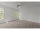 Spacious bedroom with large windows providing natural light and a ceiling fan at 707 Southshore Pkwy, Durham, NC 27703