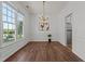 Elegant dining room featuring hardwood floors, classic trim, a stylish chandelier, and an open doorway to another living space at 707 Southshore Pkwy, Durham, NC 27703