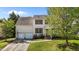 Inviting two-story home featuring a well-manicured lawn, a two-car garage, and a charming front entrance with classic design at 707 Southshore Pkwy, Durham, NC 27703