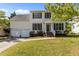 Inviting two-story home featuring a well-manicured lawn, a two-car garage, and a charming front entrance with classic design at 707 Southshore Pkwy, Durham, NC 27703