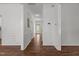 Hallway with hardwood floors and decorative trim that offers a view of the front entrance and access to various rooms at 707 Southshore Pkwy, Durham, NC 27703