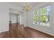 Bright living room with hardwood floors, large windows, classic trim, and an open layout connecting multiple living spaces at 707 Southshore Pkwy, Durham, NC 27703