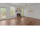 Inviting living room with a brick fireplace, lots of natural light, and hardwood floors at 707 Southshore Pkwy, Durham, NC 27703