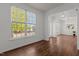 Bright living room with hardwood floors, large windows offering lush views, and an open layout leading to the dining area at 707 Southshore Pkwy, Durham, NC 27703