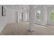 Main bedroom boasts natural lighting, plush carpet, tray ceilings, and en-suite bathroom at 707 Southshore Pkwy, Durham, NC 27703
